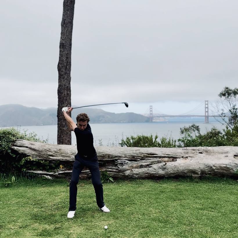 The candidate at the top of a golf swing with the Golden Gate Bridge behind him