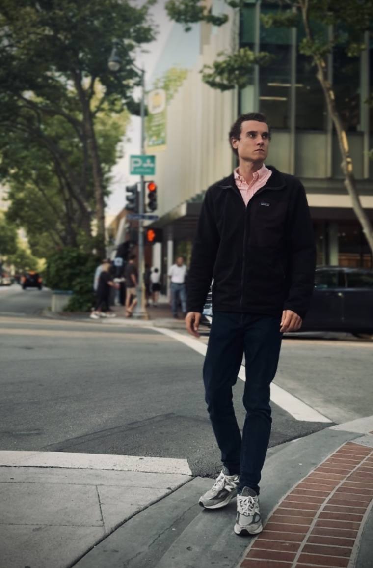 The candidate crossing a Palo Alto street in a fleece